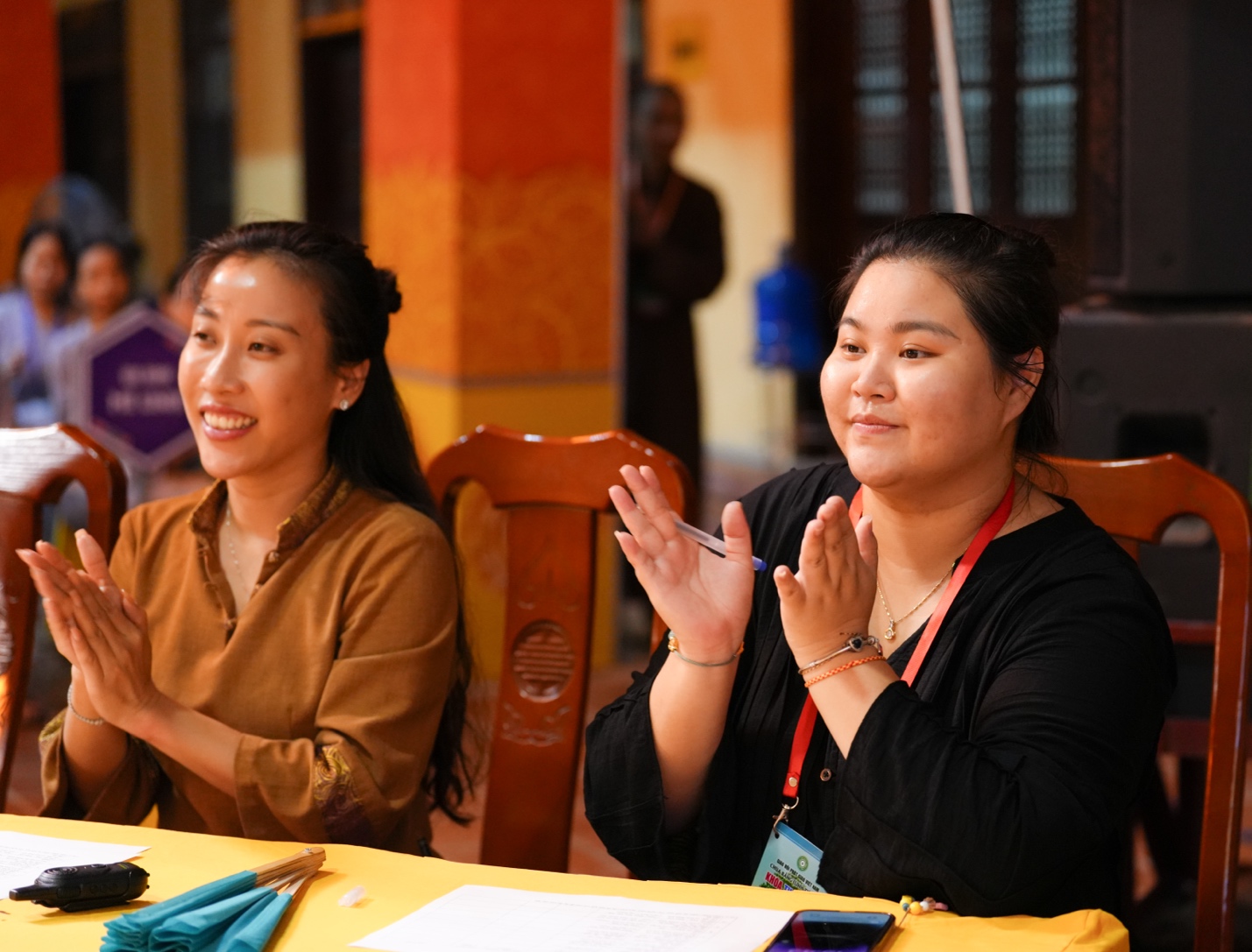 A group of women sitting at a table AI-generated content may be incorrect.
