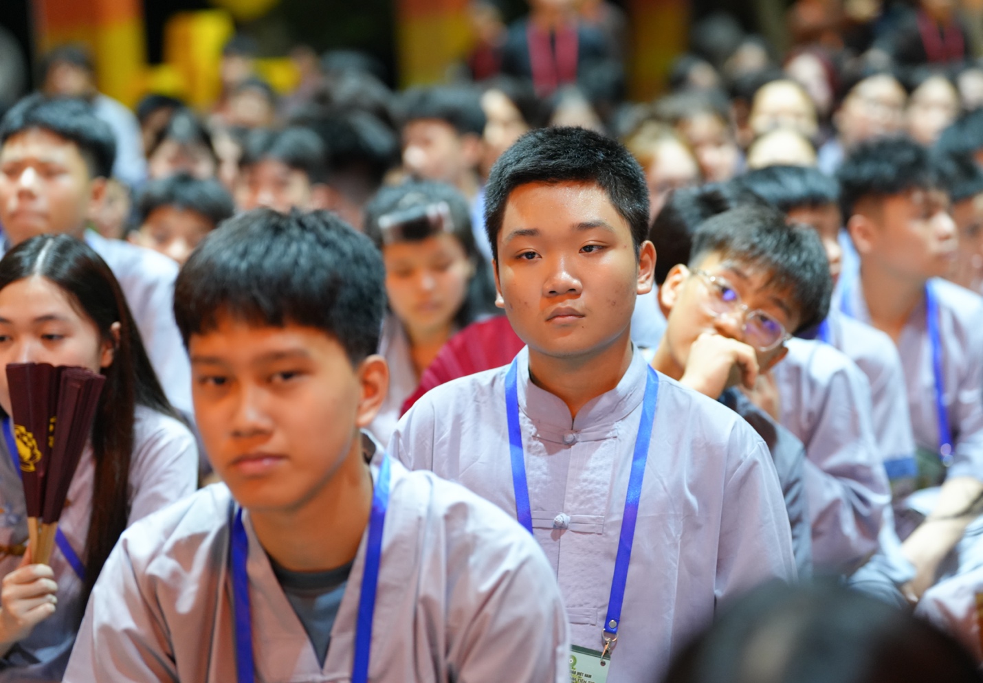 A group of young people in a crowd AI-generated content may be incorrect.
