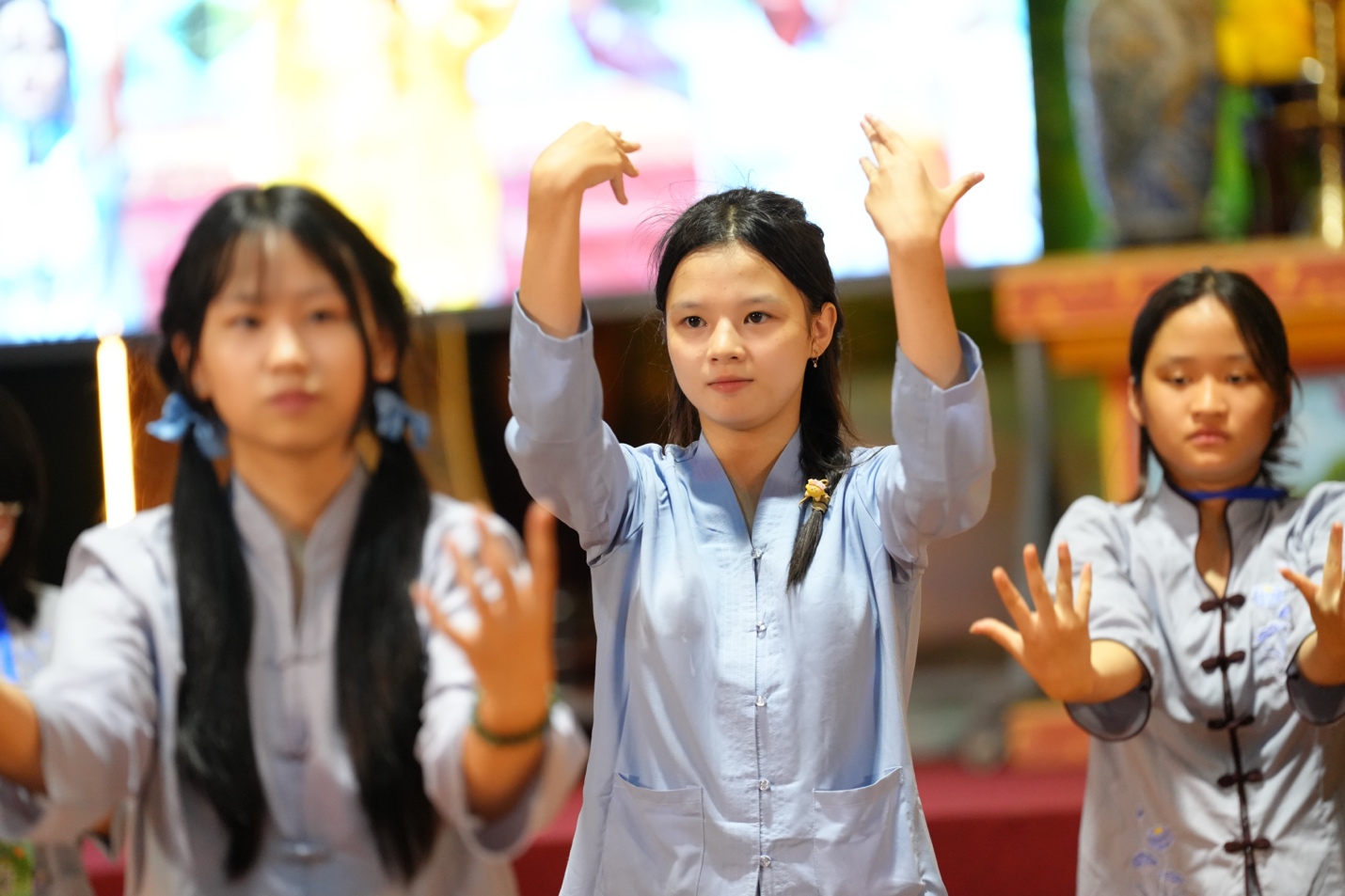 A group of young women raising their hands AI-generated content may be incorrect.