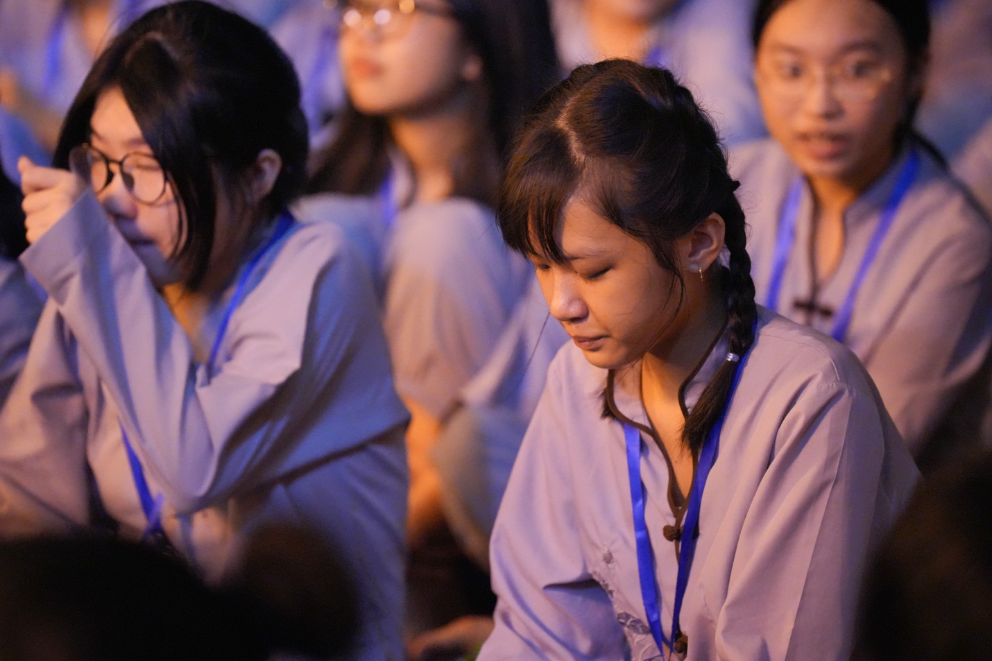 A group of young women sitting in a room AI-generated content may be incorrect.