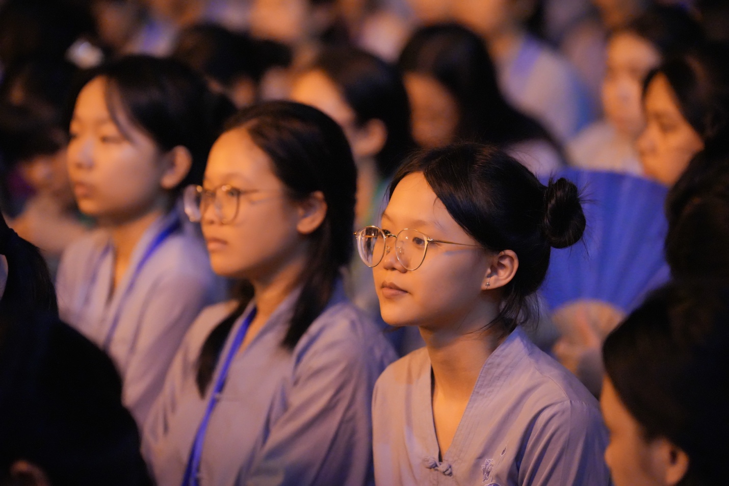 A group of young women sitting in a row AI-generated content may be incorrect.