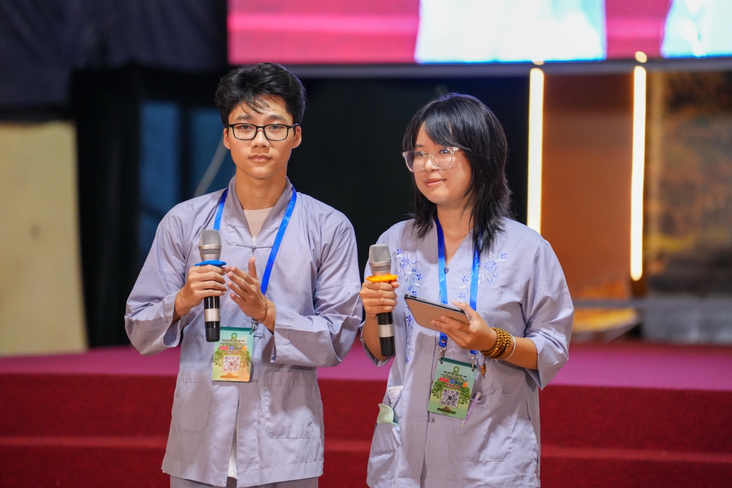A person and person holding microphones and tablet AI-generated content may be incorrect.