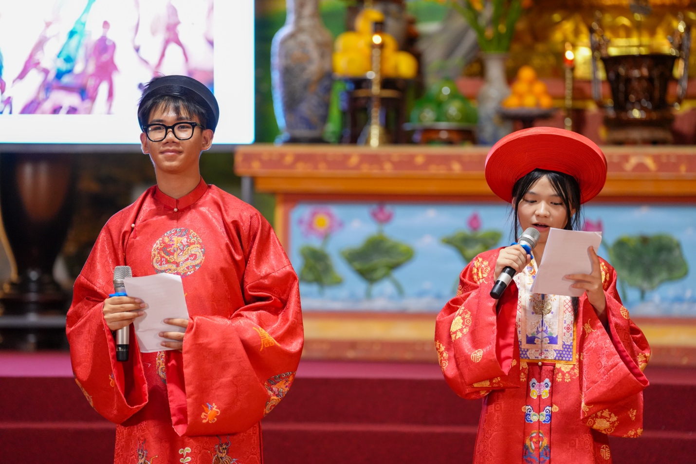 A person and person in red robes holding microphones AI-generated content may be incorrect.