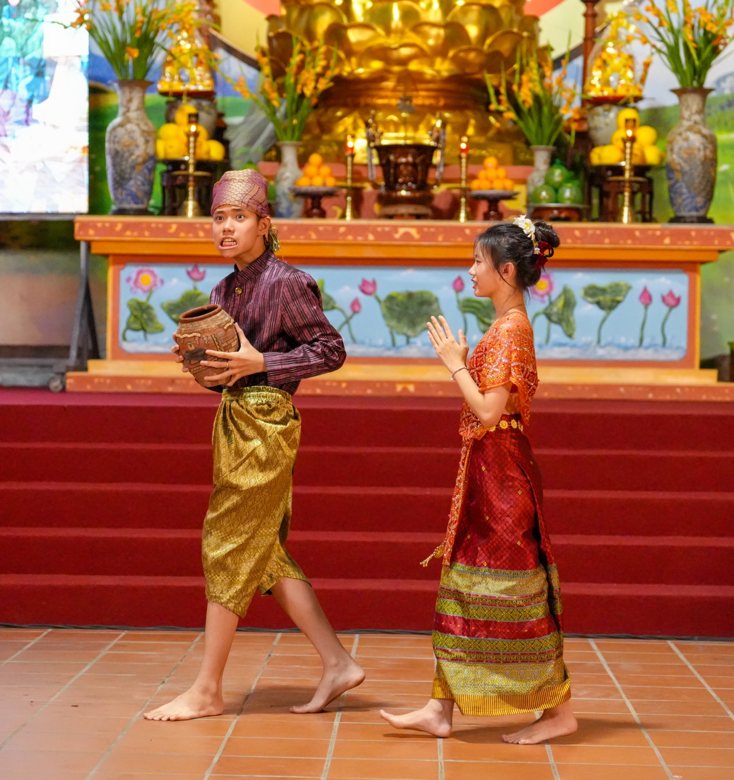 A person and person in traditional dress walking on red stairs AI-generated content may be incorrect.