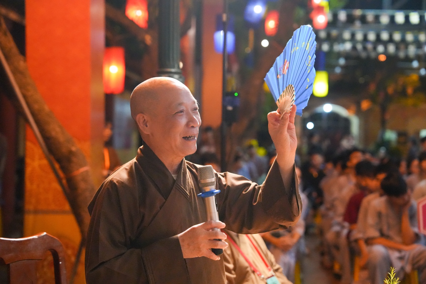 A person holding a blue fan AI-generated content may be incorrect.