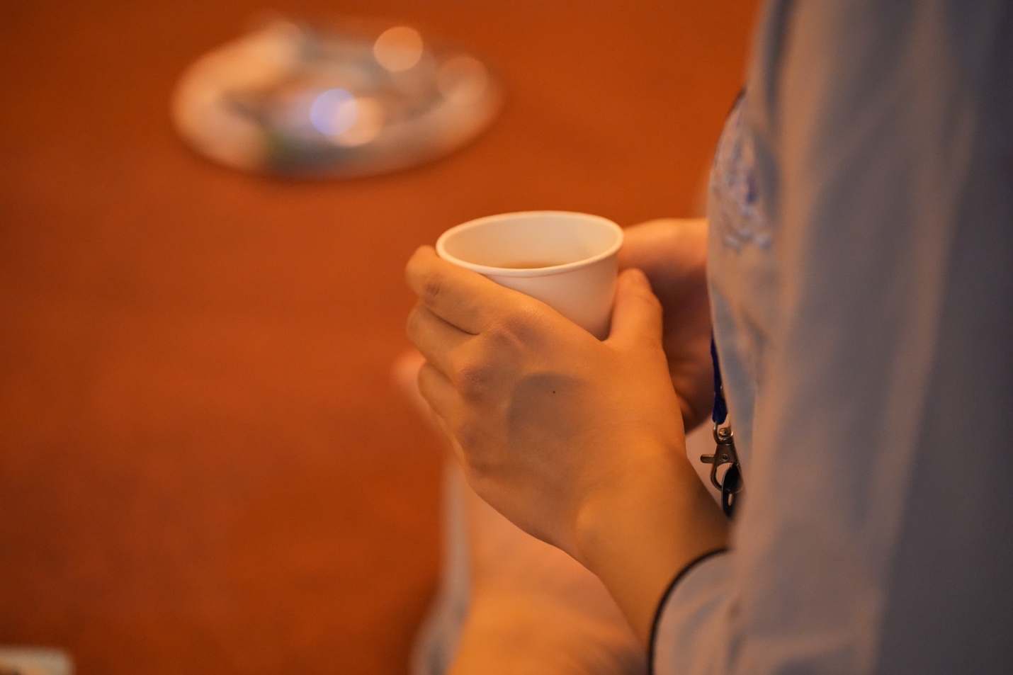 A person holding a cup of coffee AI-generated content may be incorrect.