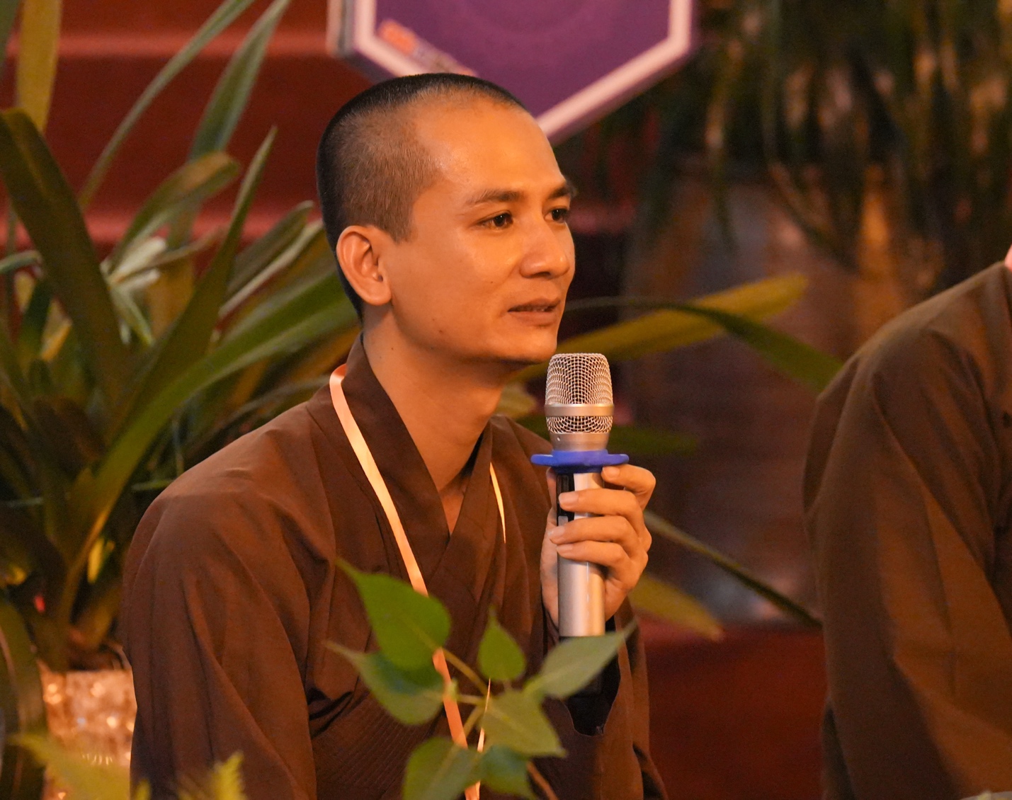 A person holding a microphone AI-generated content may be incorrect.