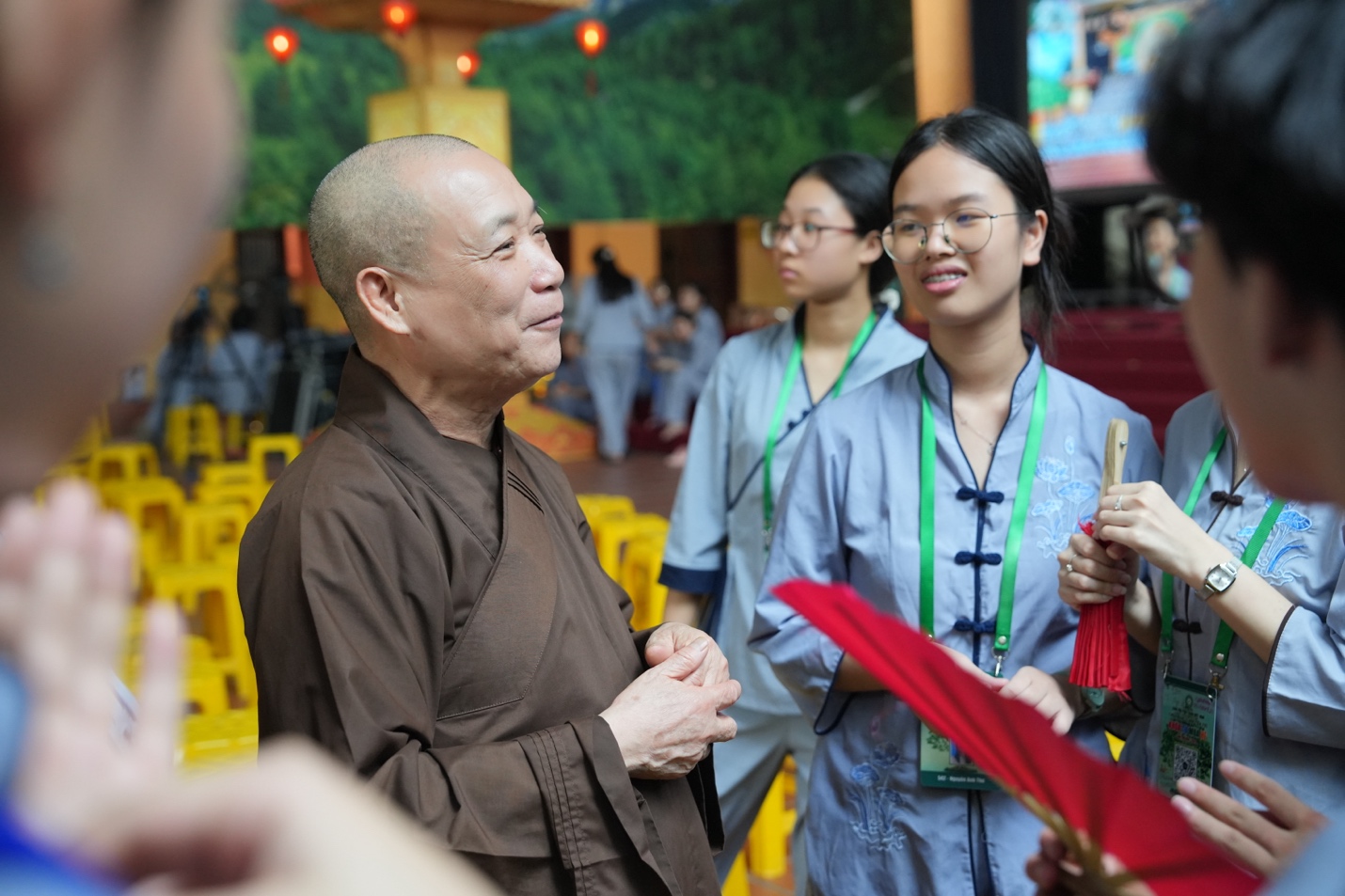 A person in a brown robe talking to a group of people AI-generated content may be incorrect.