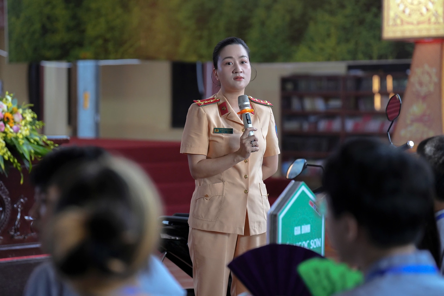 A person in a military uniform holding a microphone

AI-generated content may be incorrect.
