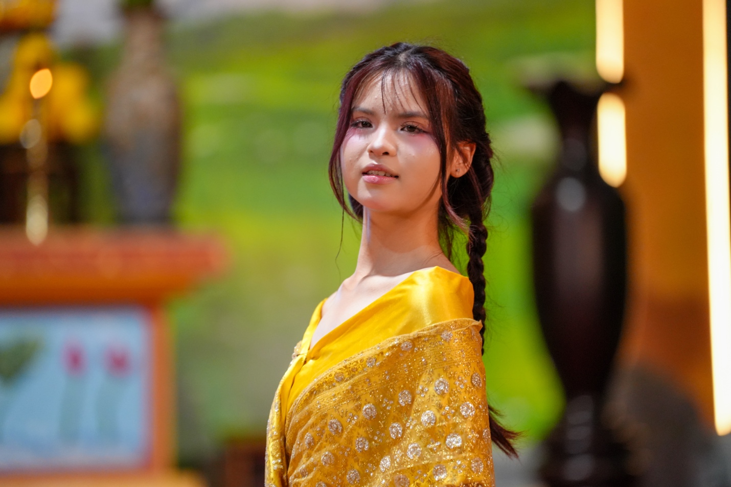 A person in a yellow dress AI-generated content may be incorrect.