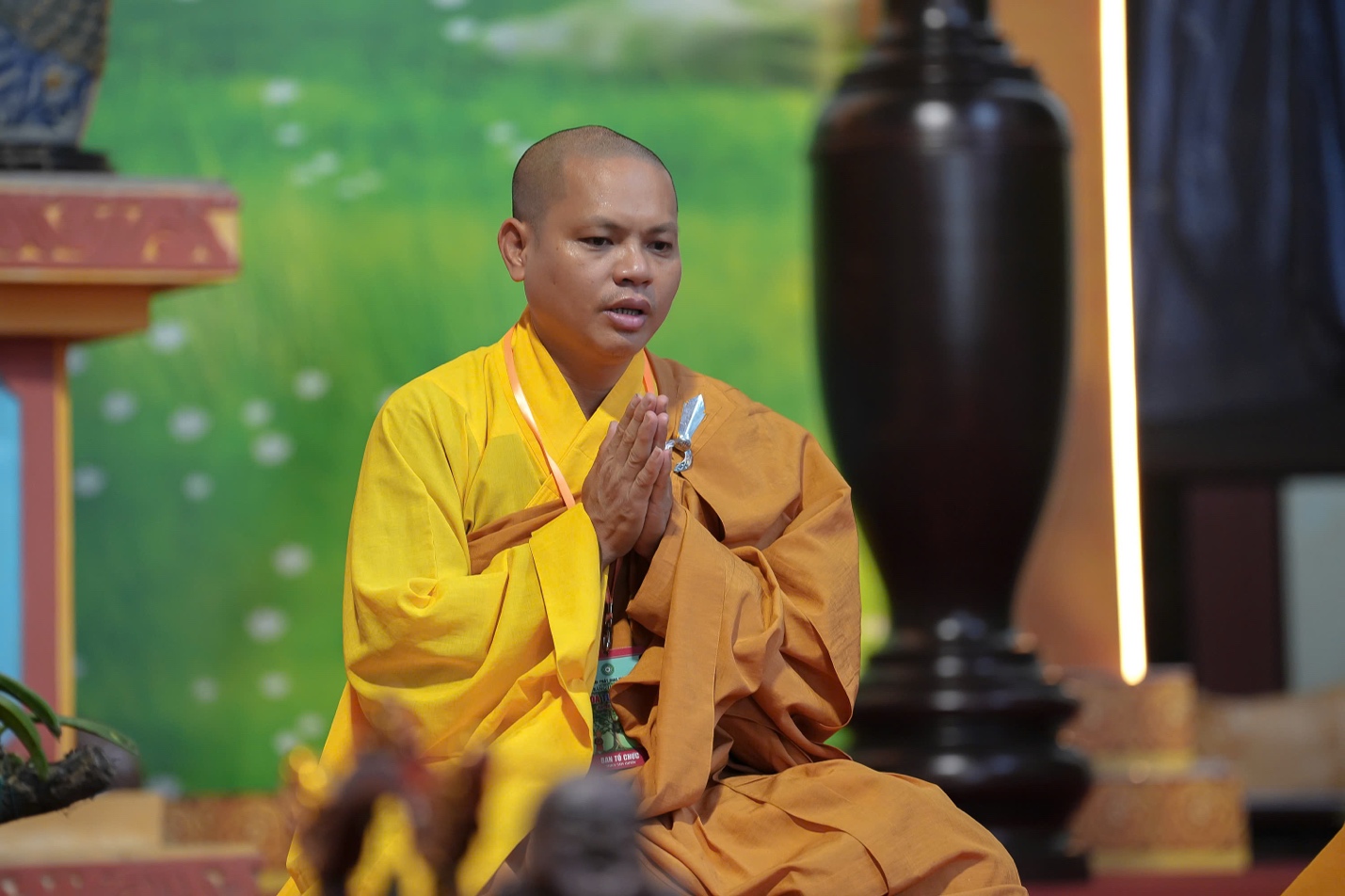 A person in a yellow robe AI-generated content may be incorrect.