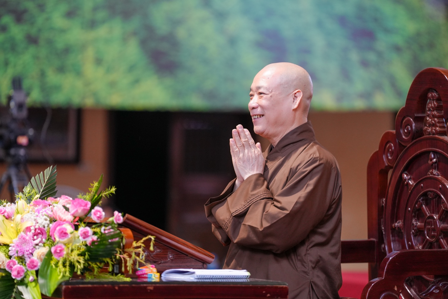 A person in brown robe standing at a podium AI-generated content may be incorrect.