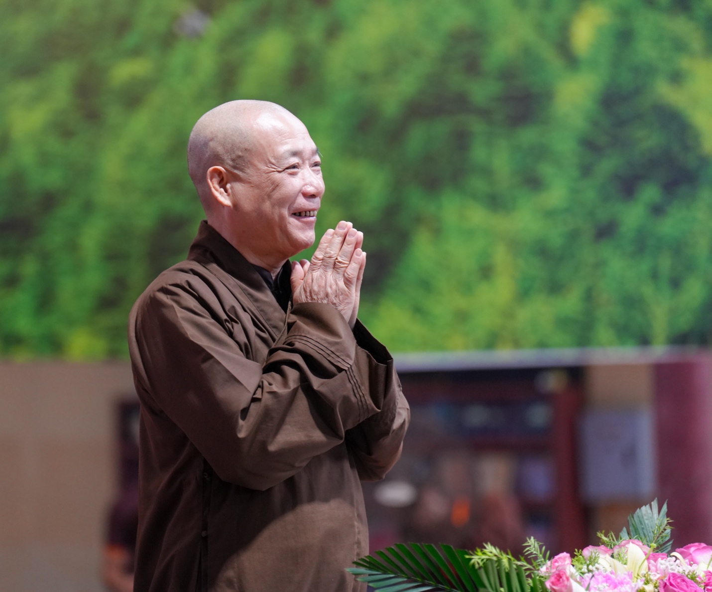 A person in brown robe with hands together AI-generated content may be incorrect.