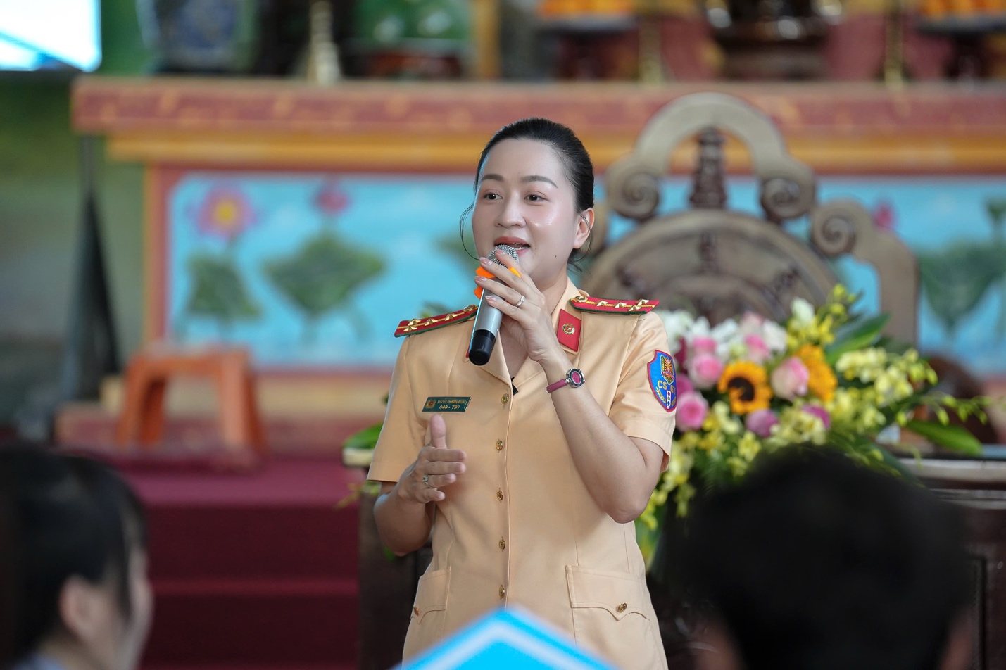 A person in uniform speaking into a microphone

AI-generated content may be incorrect.