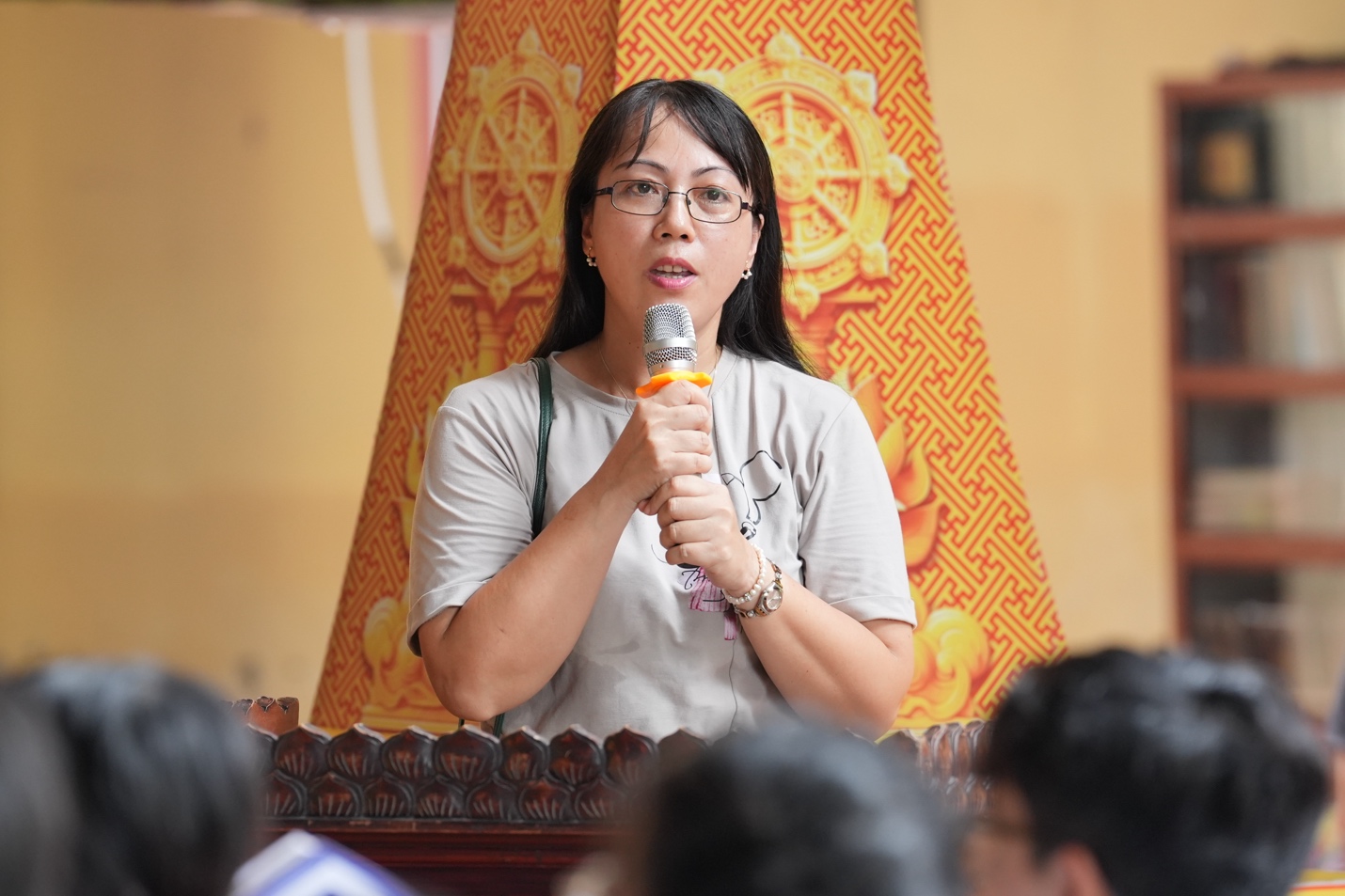 A person speaking into a microphone AI-generated content may be incorrect.