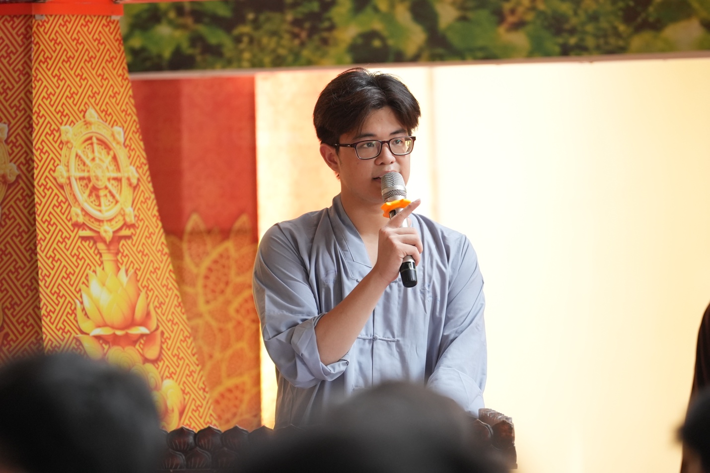 A person speaking into a microphone AI-generated content may be incorrect.