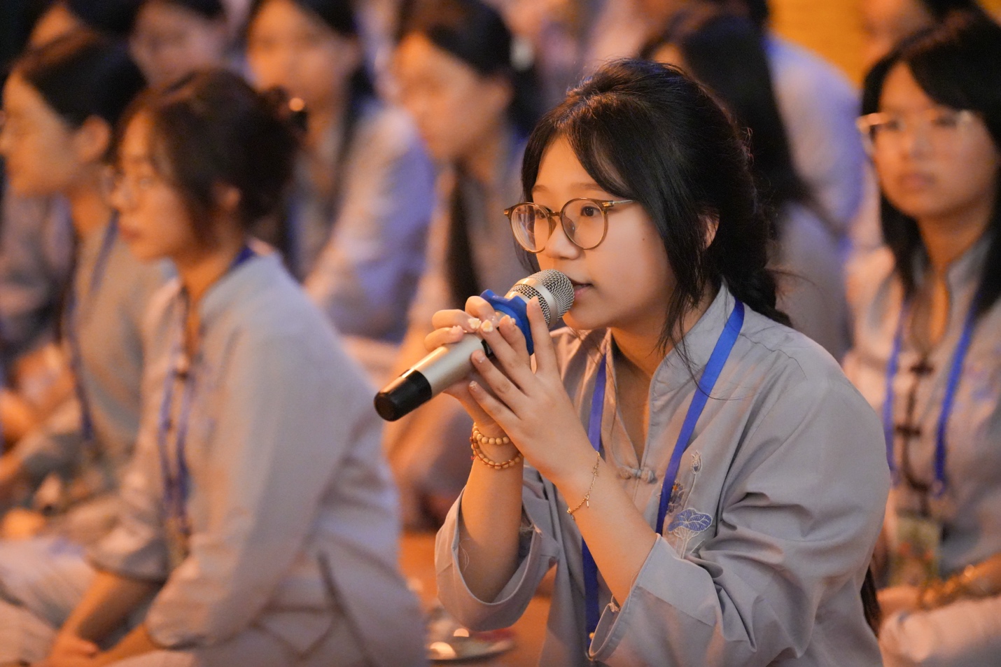 A person speaking into a microphone AI-generated content may be incorrect.