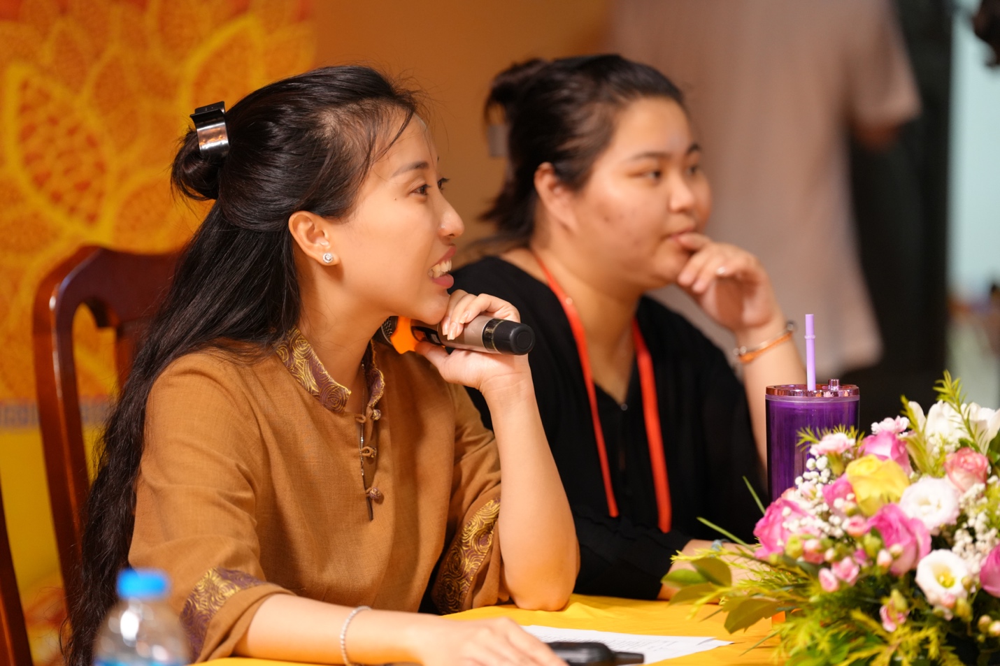 A person talking on a microphone AI-generated content may be incorrect.
