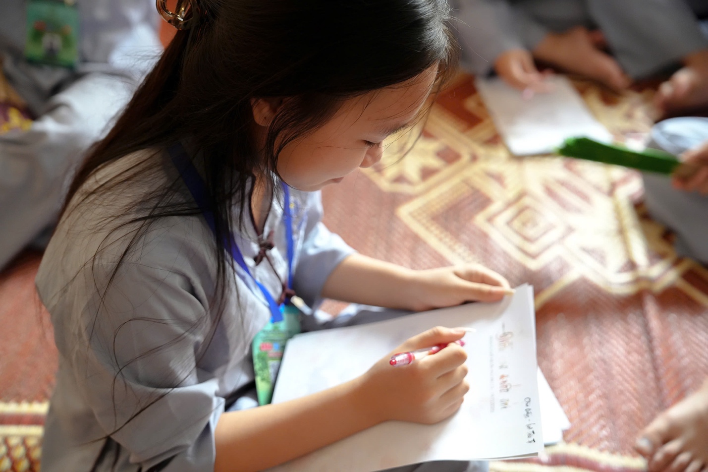 A young child writing on a piece of paper

AI-generated content may be incorrect.