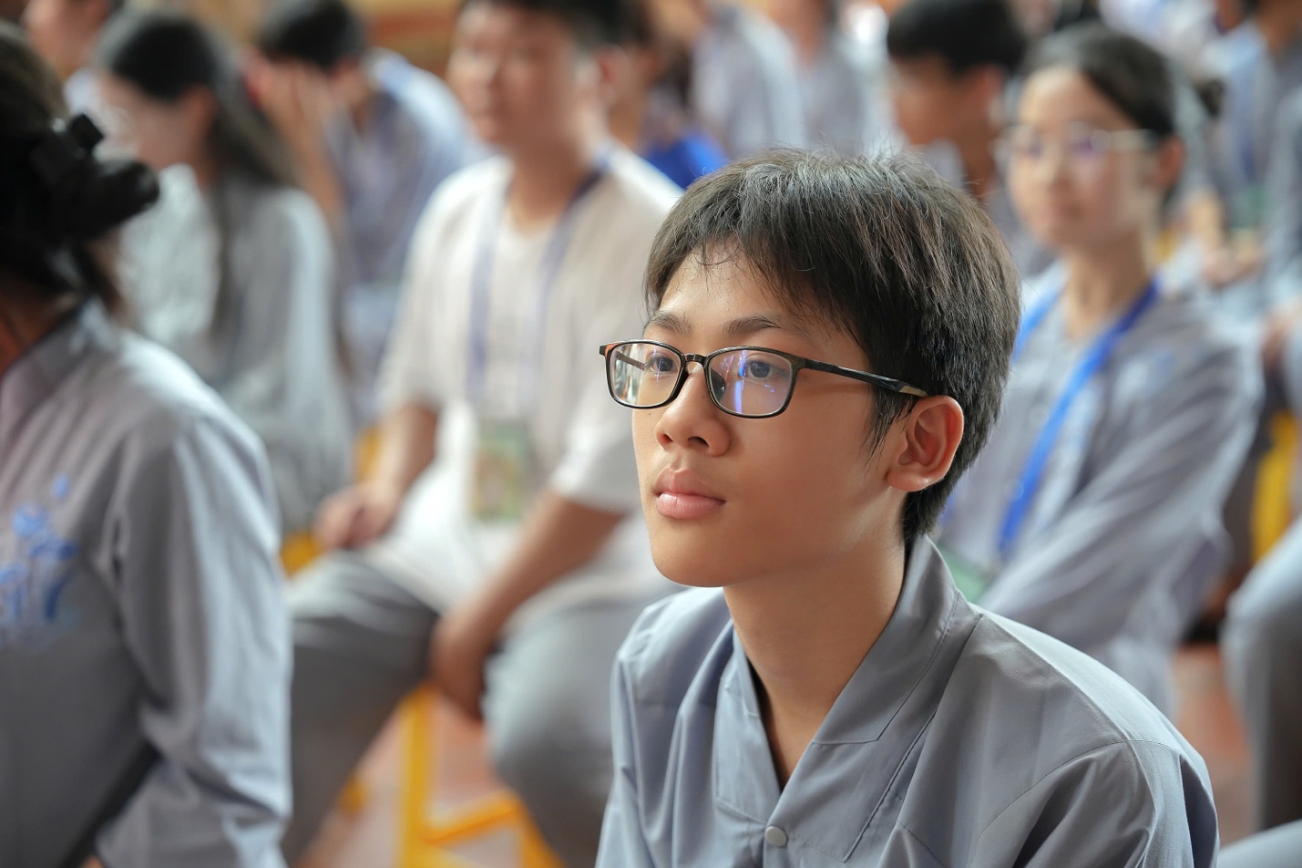 A young person wearing glasses AI-generated content may be incorrect.