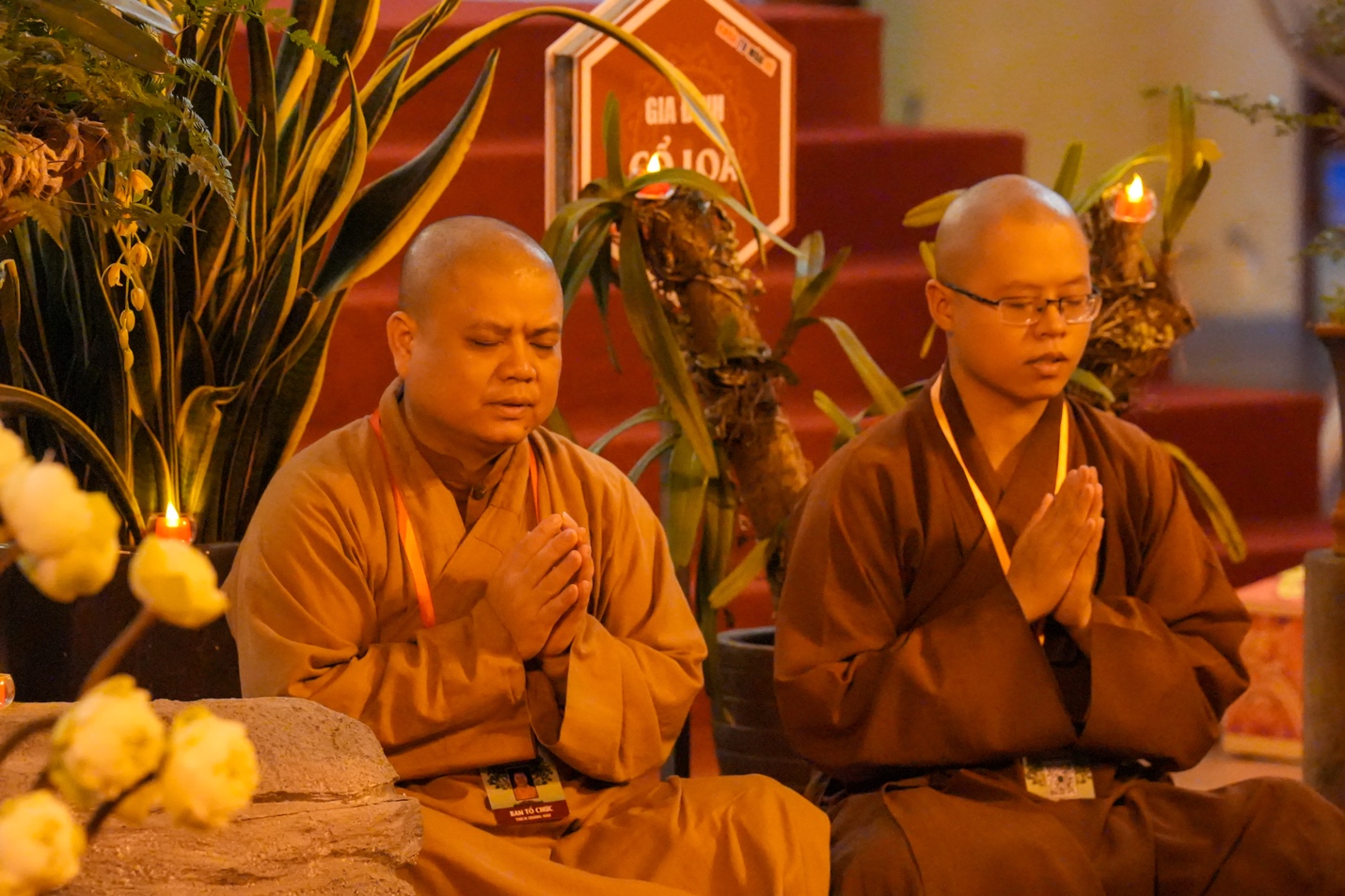 Two men in robes praying AI-generated content may be incorrect.