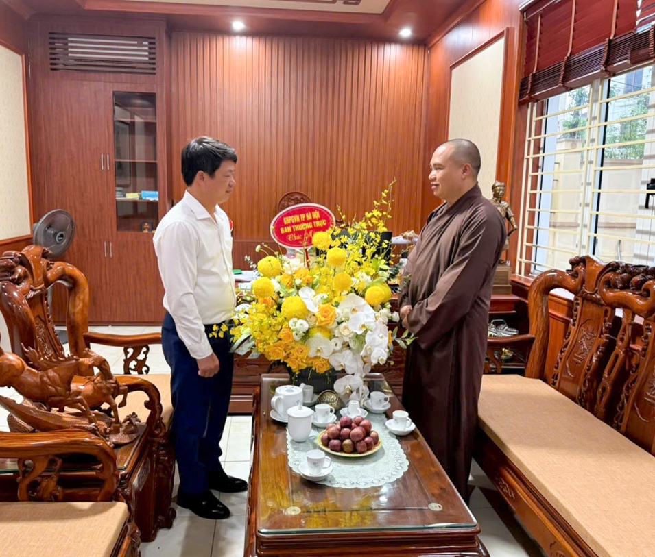 Two men standing in a room with a table full of flowers AI-generated content may be incorrect.