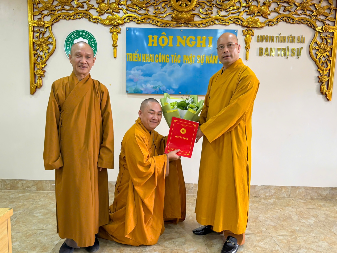 A group of men in orange robes holding a red book AI-generated content may be incorrect.