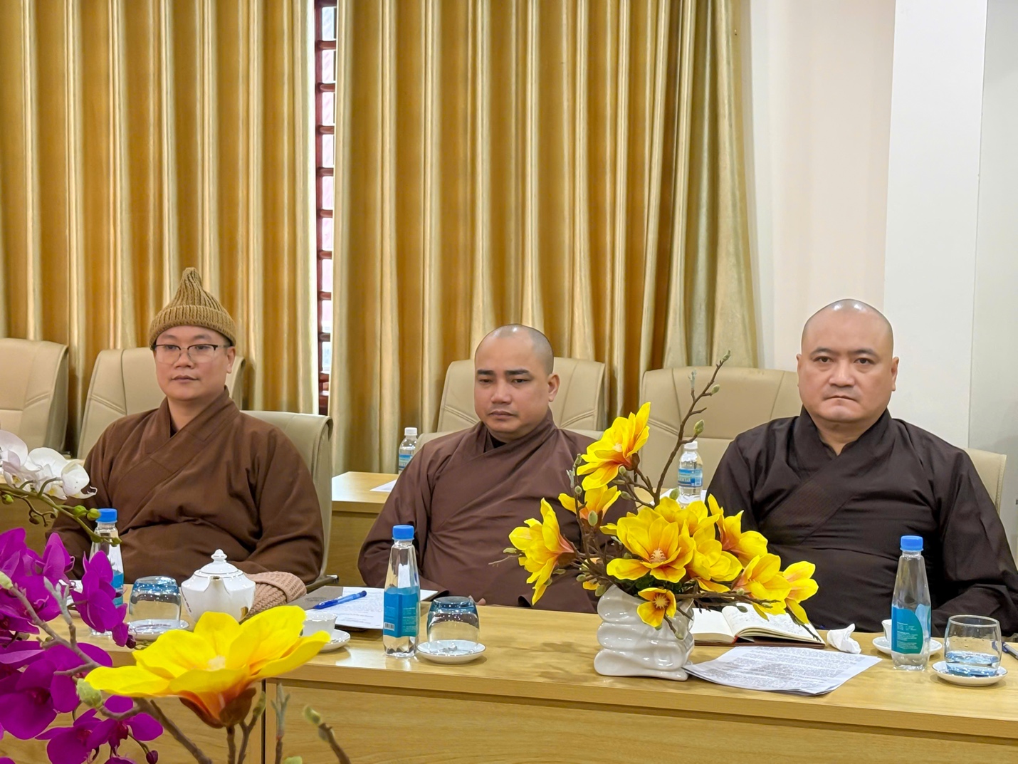 A group of people sitting at a table AI-generated content may be incorrect.