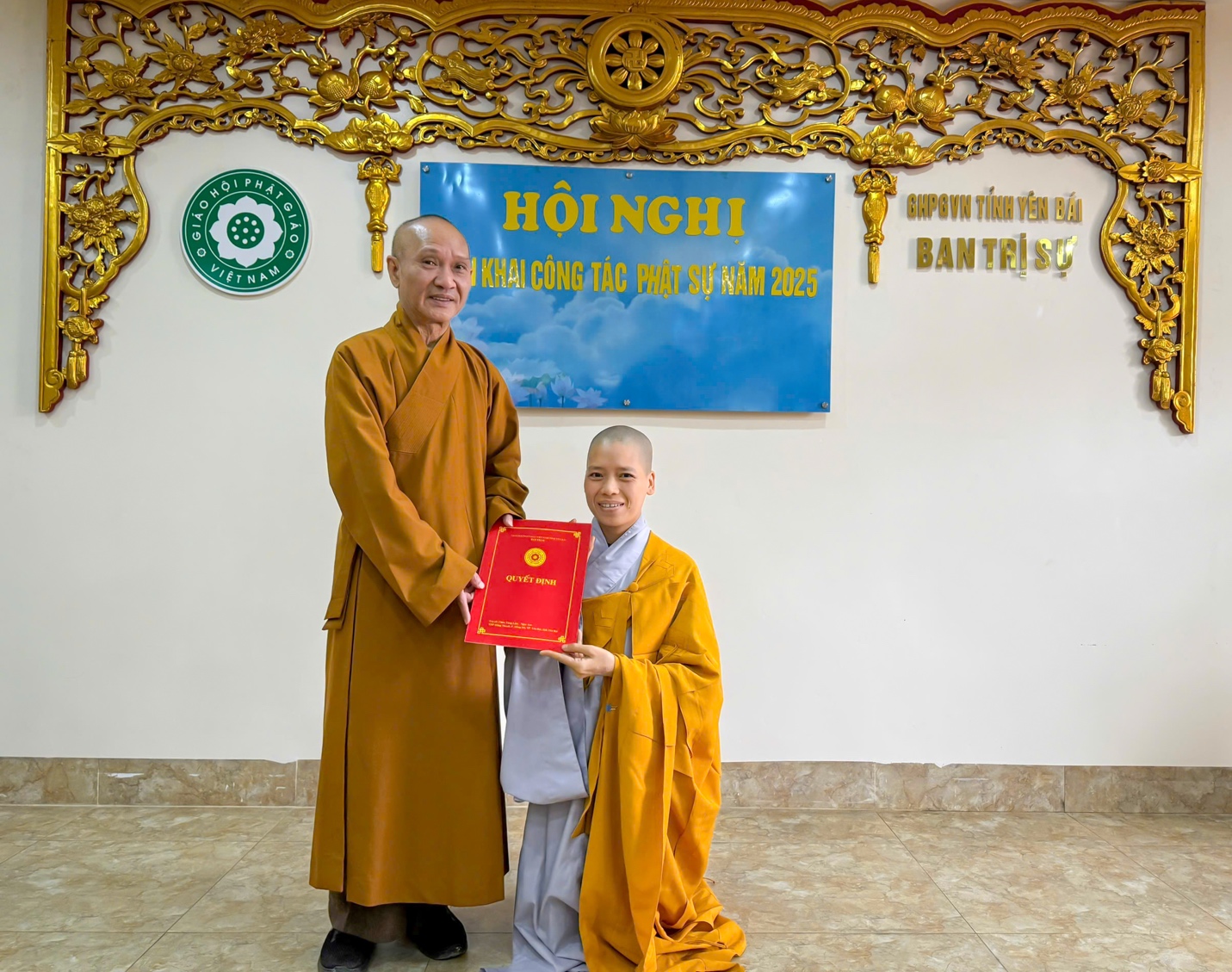 A person and person in robes holding a red book AI-generated content may be incorrect.